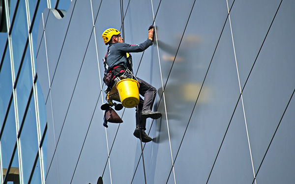 Worker cleaning building walls